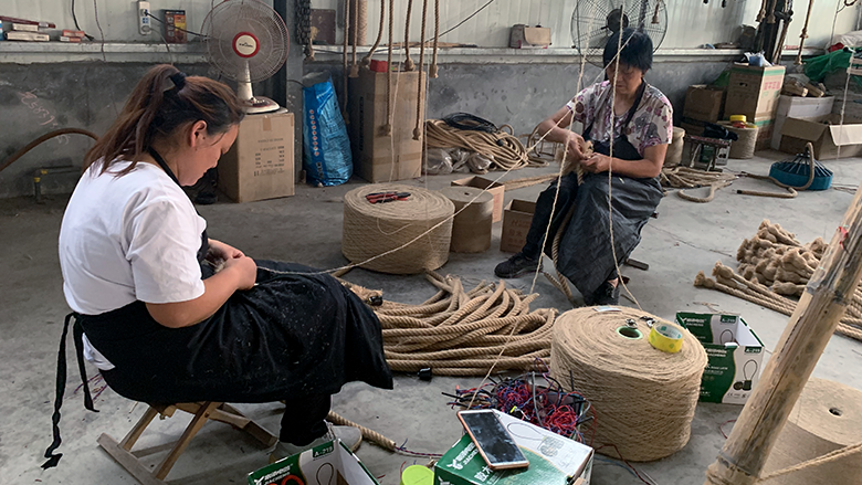 Two women weave rope in one of China